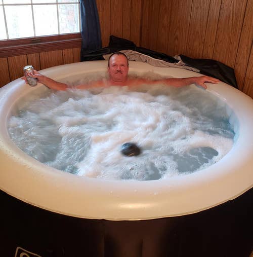 a reviewer sitting in the hot tub with the jets turned on