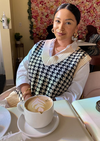 Daily News | Online News reviewer wearing the black and white sweater vest over a white long sleeve shirt