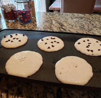 same reviewer's perfectly round pancakes cooking on a griddle, some plain, some with chocolate chips