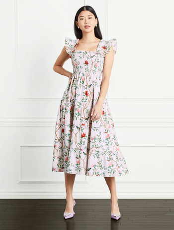 model wearing the pink floral print dress with lavender heels