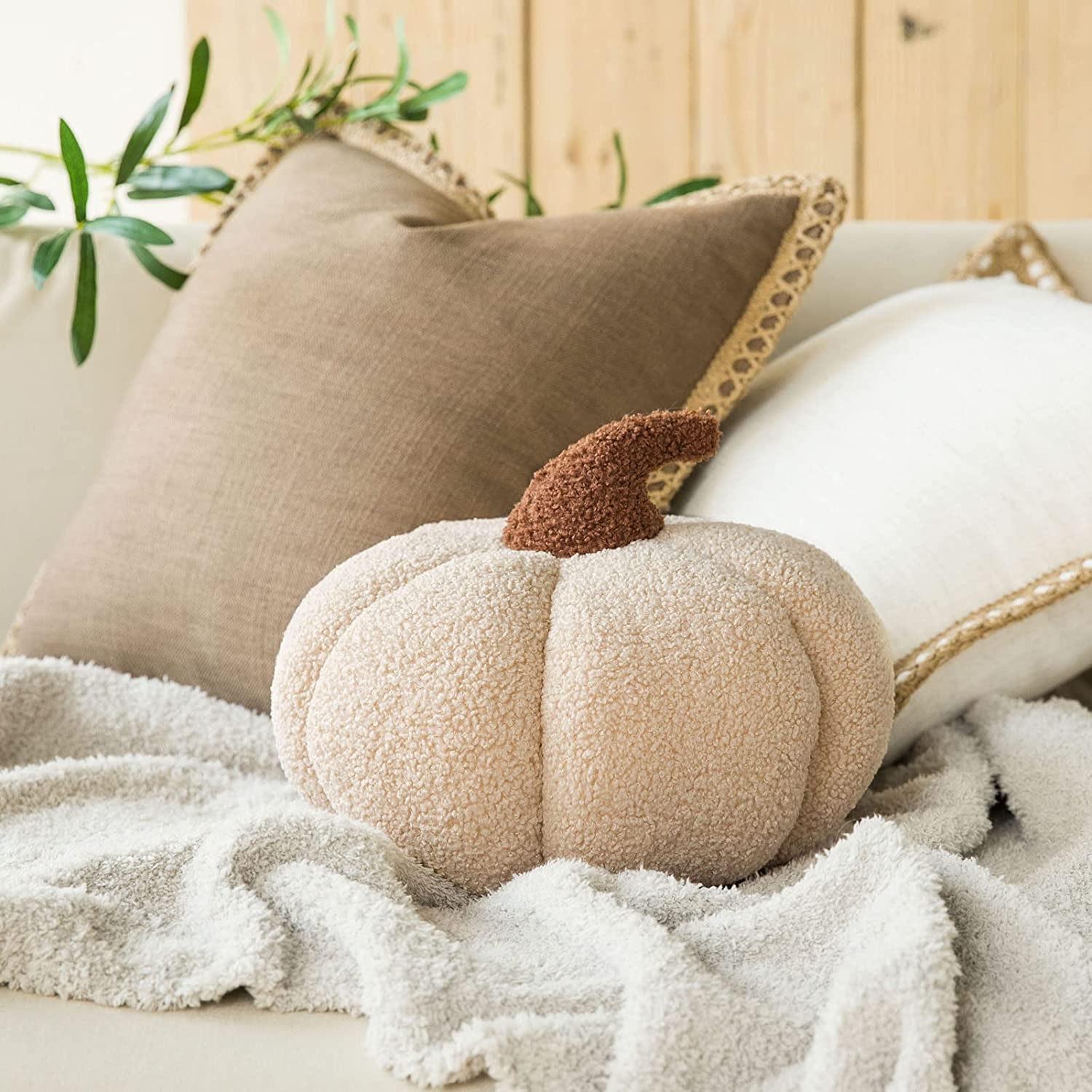 A pale cream stuffed sherpa pumpkin pillow
