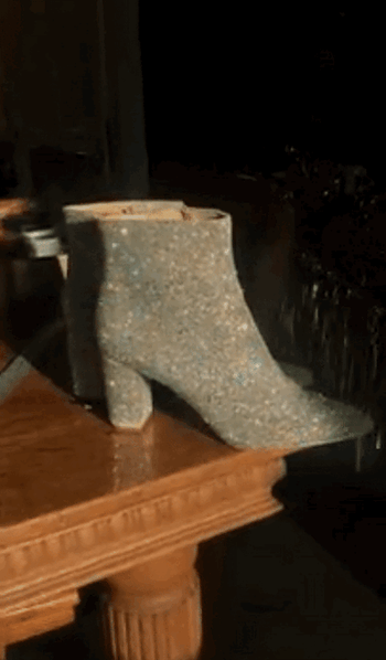 gif of a reviewer's video showing off their sparkly silver booties