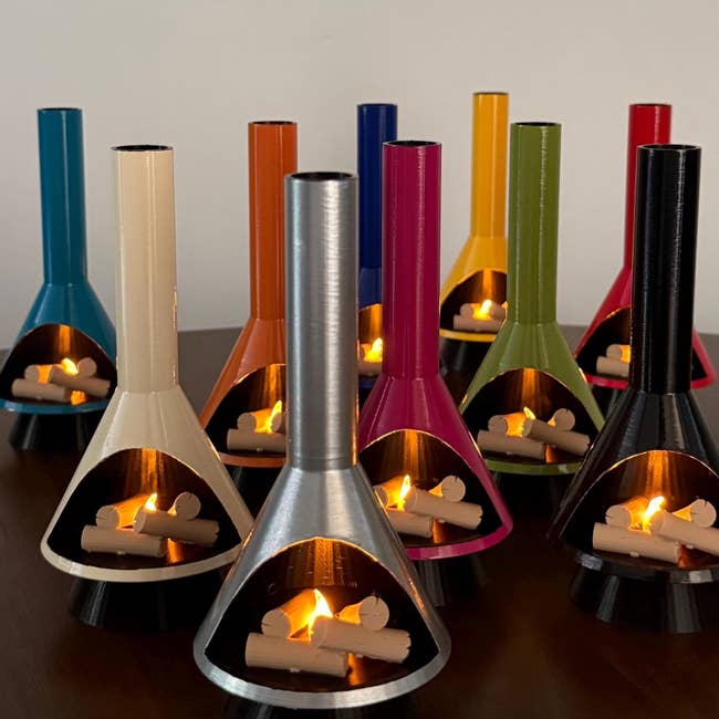 Assorted decorative candle holders successful assorted styles with lit candles, arranged connected a table. Suitable for location decor buying article