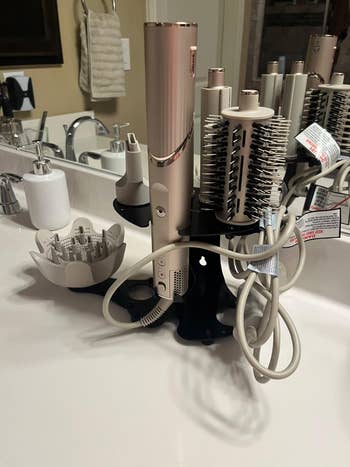 Hair styling instrumentality kit with aggregate attachments connected a bath counter, featuring a brushwood and curling options