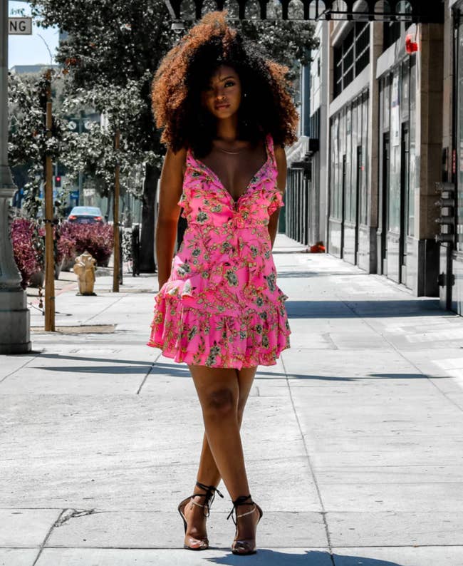 a model wearing the floral ruffled dress