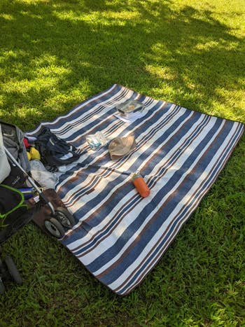striped picnic blanket spread out on grass