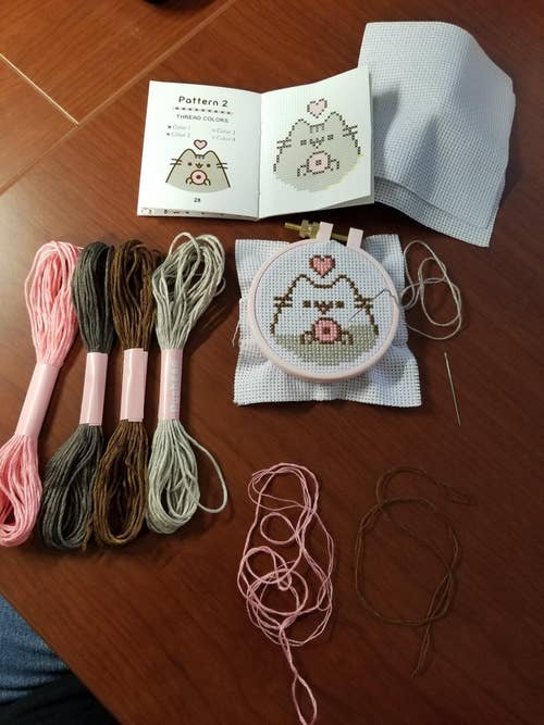 the kit, with a reviewer's started cross stitch