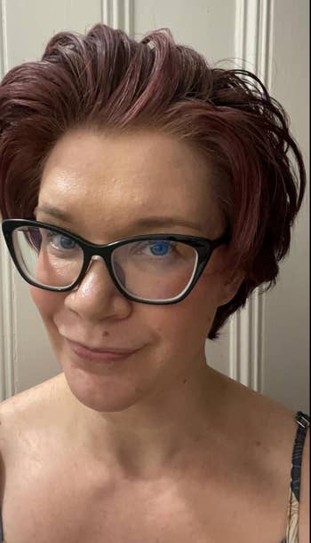 Person with stylish abbreviated  hairsbreadth  and glasses taking a selfie indoors, wearing a vessel  top