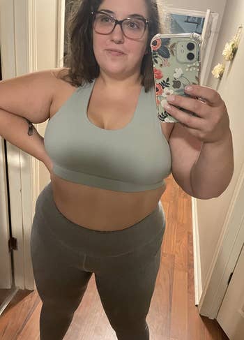 reviewer wearing the gray bra with gray leggings