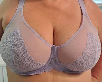 reviewer close-up of a lace-trimmed lavender bra being worn