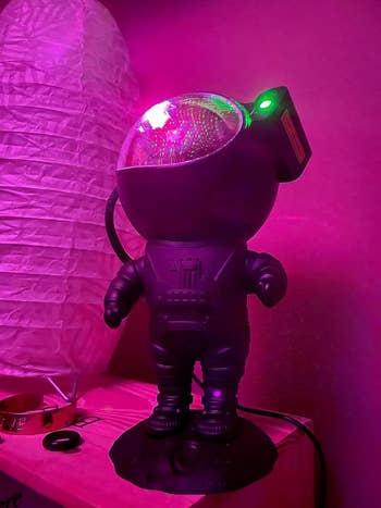 The astronaut figure with the projector in its helmet visor