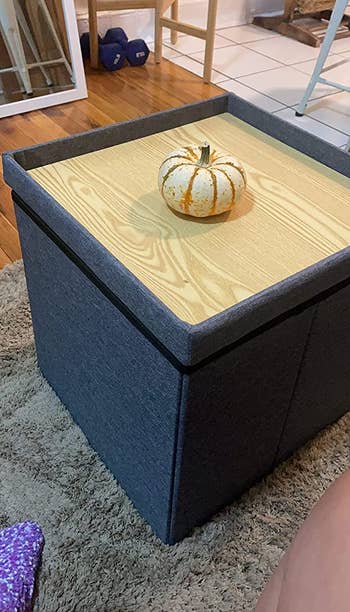 reviewer photo of cube storage ottoman with a pumpkin on it