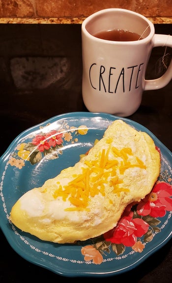 An omelet with cheese sprinkled on top