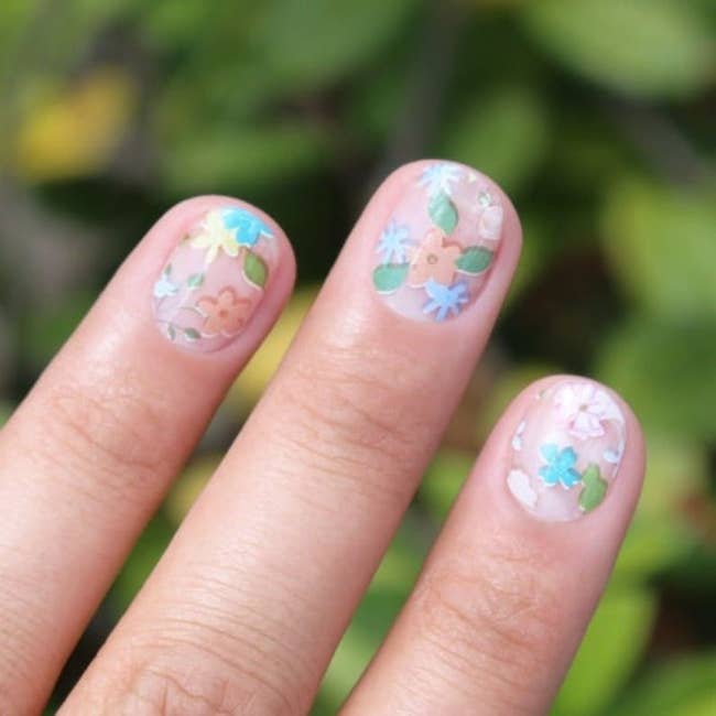 Close-up of nails with floral-themed art