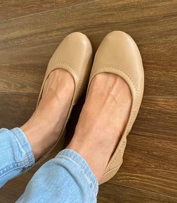 reviewer wearing tan flats with jeans