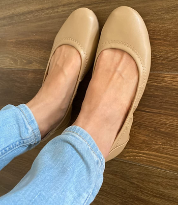 reviewer wearing tan flats with jeans