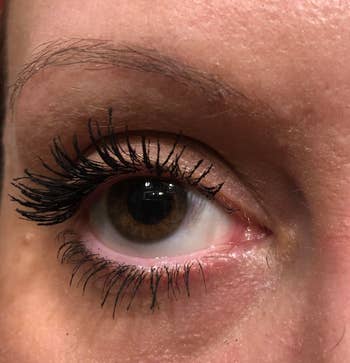 the same reviewer with very full, long lashes after applying the mascara