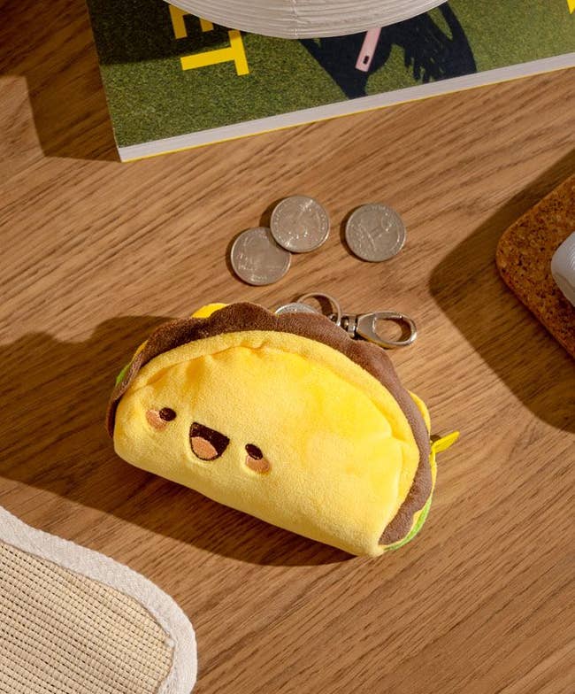 Plush coin pouch shaped like taco with face
