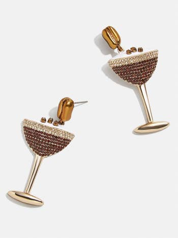Earrings shaped similar cocktail glasses adorned with sparkling stones and gold-tone details