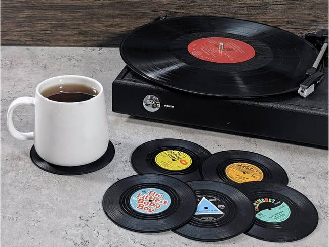 vinyl coasters next to a mug of coffee