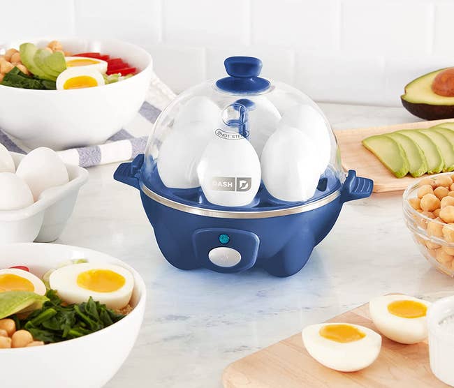 the blue rapid egg cooker with six eggs inside of it