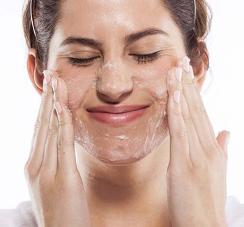 a model applying the face polish