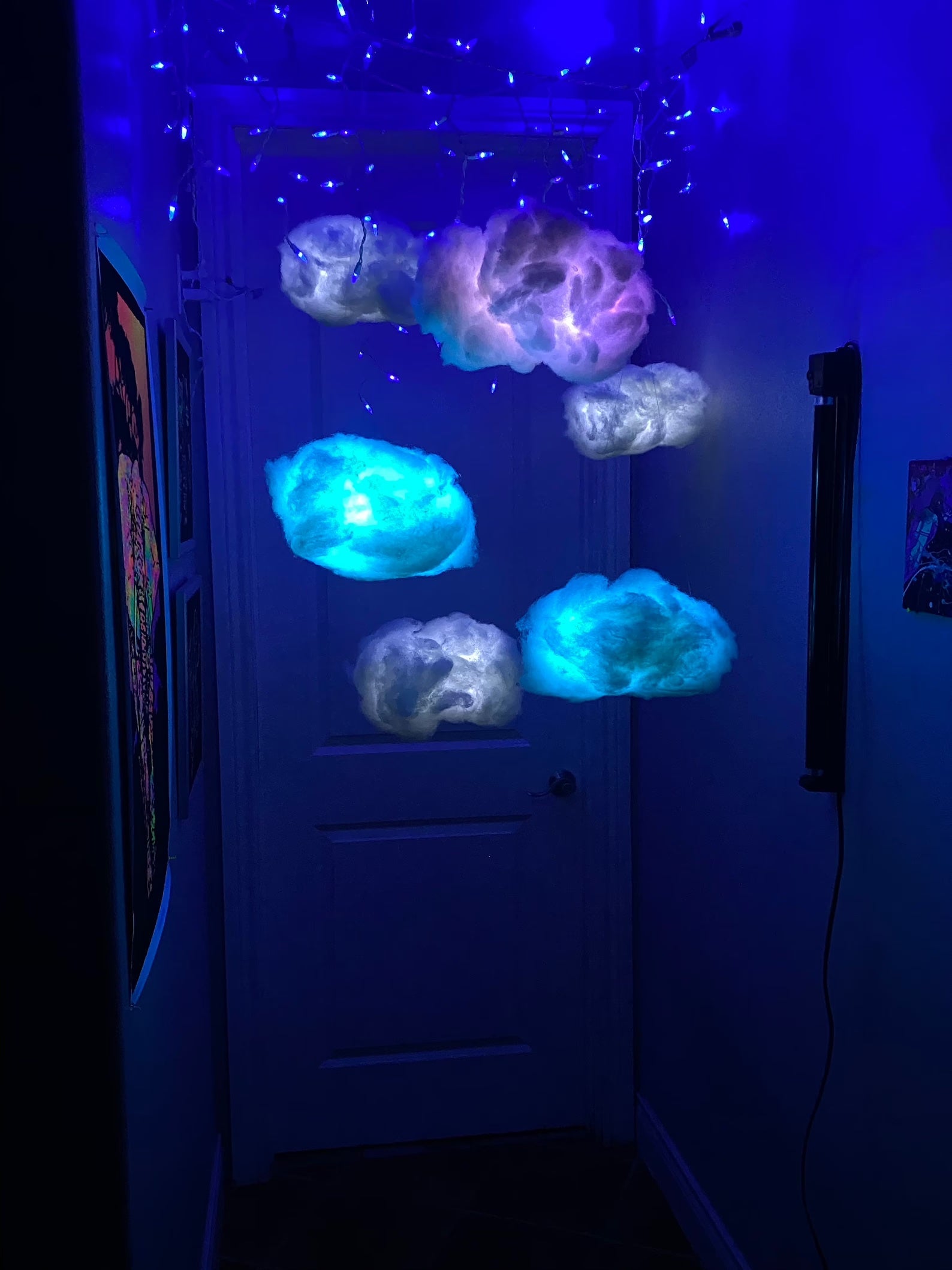 various size cloud like LED lights hanging from the ceiling