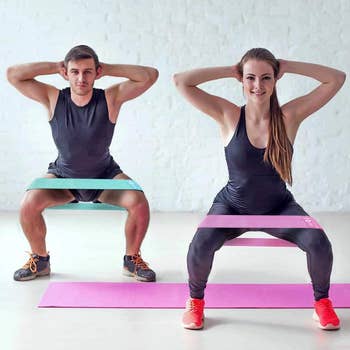 models squat with green and pink resistance bands