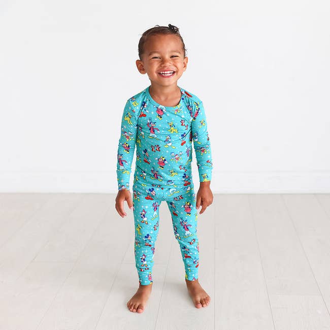 blue stretchy two piece pajamas with disney characters on them