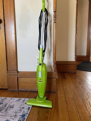 the stick vacuum in light green