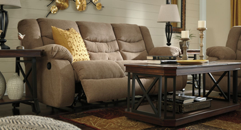 beige reclining sofa with footrest up