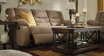 beige reclining sofa with footrest up