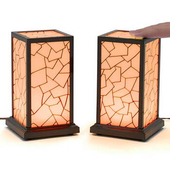 two rectangle lamps with a hand on one