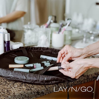lifestyle image of makeup splayed out in Lay-n-Go bag