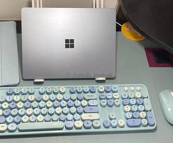 reviewer photo of the blue keyboard set up on their desk