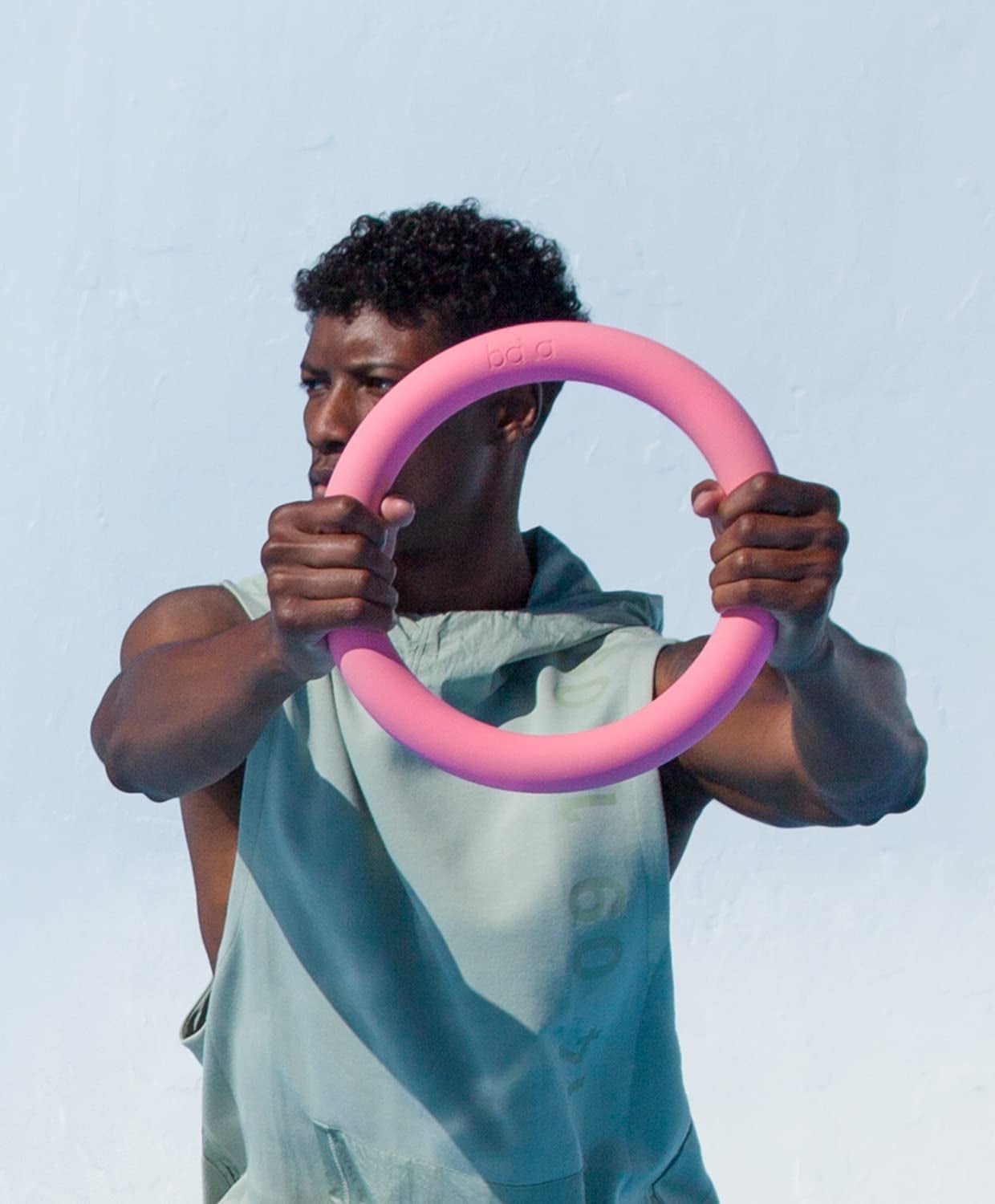 model holds pink Bala Power Ring in arms while working out