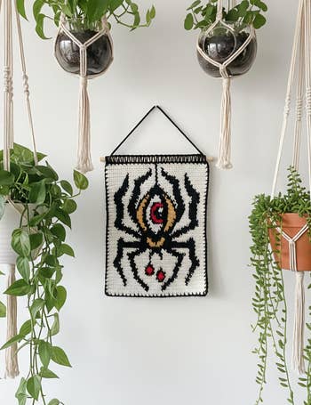 A tapestry featuring a stylized spider design