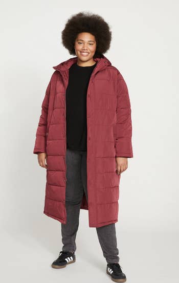 model wearing the red coat unzipped