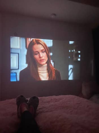 reviewer watching a show on the projector