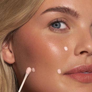a model using the drying cream on their face
