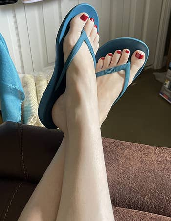 reviewer wearing sea blue sandals