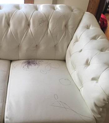 a white couch with pen marks all over it