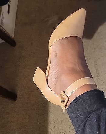 reviewer wearing the low-heeled faux leather pumps in tan