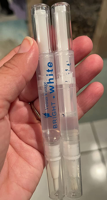 reviewer holding the pair of whitening pens