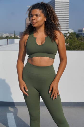 reviewer wearing the set in green, showing up close how it's made with ribbed fabric