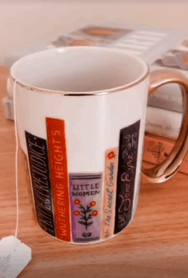a gif of a a white mug with illustrated novels on it
