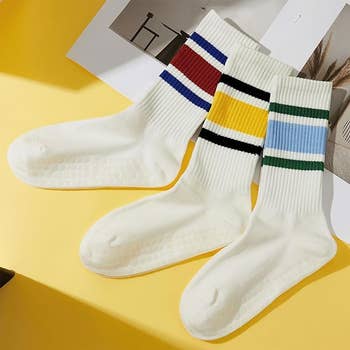 White socks with thin and thick stripes around the ankle in various colors