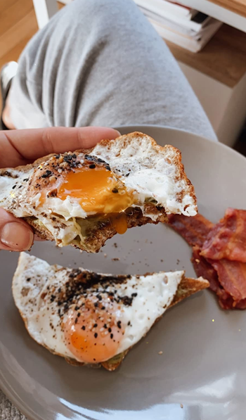 Reviewer image of sunny side up eggs with seasoning on them 