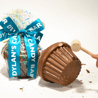 gif of giant cupcake shaped chocolate being smashed open, revealing candy inside