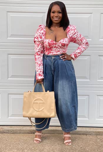 a reviewer wearing the loose bloomers with a floral cropped blouse